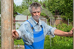 Man is a builder on a real construction site in nature. Construction of a house.