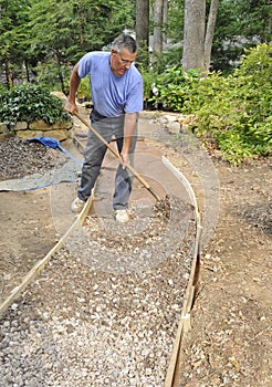 Man building gravel path