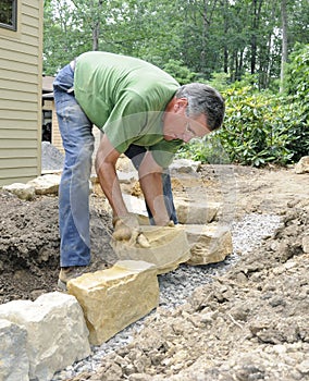 Man building stone wall