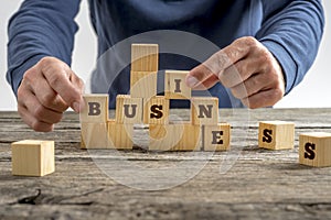 Man building the word Business with blocks