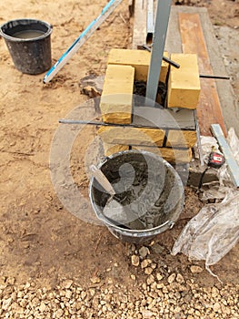 Man builds a brick wall at a construction site