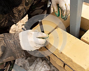 Man builds a brick wall at a construction site