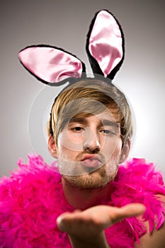 Man in bunny ears blowing kiss