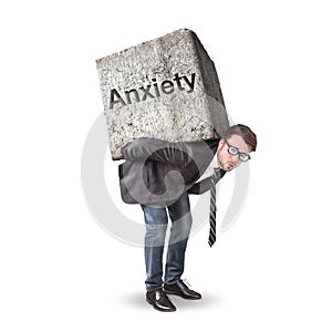 Man burdened by a heavy stone labeled with Anxiety photo