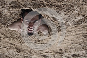 Man buried in sand 