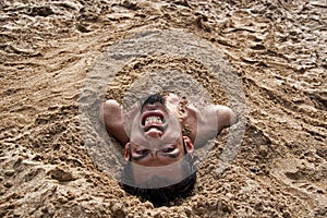 Man buried in sand 