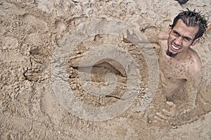 Man buried in sand 