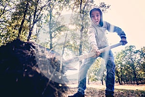 A man buries the ground with a shovel and throws it from above, a view from inside from below