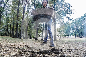 A man buries the ground with a shovel and throws it from above, a view from inside from below