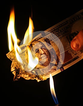 Man is burning money. Dollars photo. Greedy corruption concept. Bribe idea. Inflation rates. Price growth