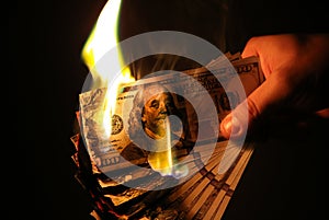 Man is burning money. Dollars photo. Greedy corruption concept. Bribe idea. Inflation rates. Price growth