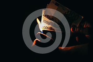 Man is burning money. Euros photo. Greedy corruption concept. Bribe idea. Cents coins. Inflation rates. Price growth