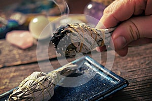 Man burning white sage incense photo