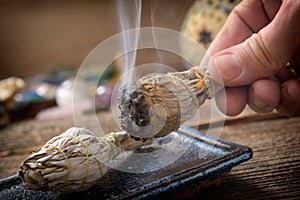 Man burning white sage incense