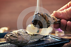 Man burning white sage incense