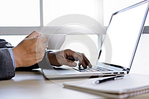 man of business man hand working on laptop computer blank white