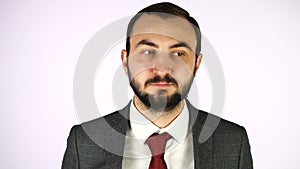 Man in business suit with brown eyes and moving fast pupils against white background