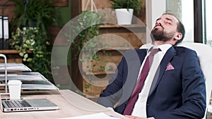 Man in business suit fell asleep at his desk