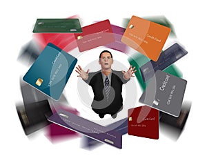 A man in a business suit grasps for credit cards that swirl overhead in this 3-D illustration