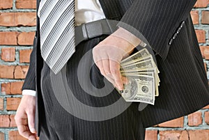 Man in a business suit put money in your pocket