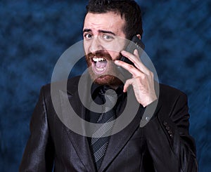Man in business suit shouting into his mobile phone