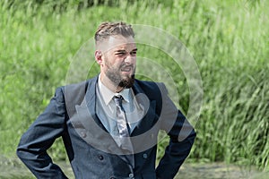 A man in a business suit in the swamp on a sunny day