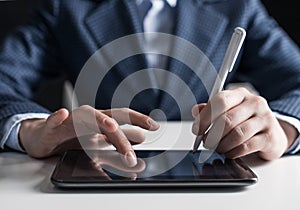 Man in business suit using digital tablet computer