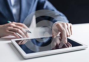 Man in business suit using tablet computer