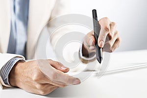 Man in business suit using tablet computer.