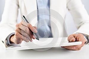 Man in business suit using tablet computer