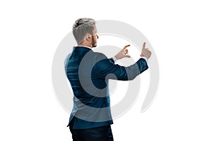 A man, a businessman in a business suit is isolated on a white background, points at something with his finger