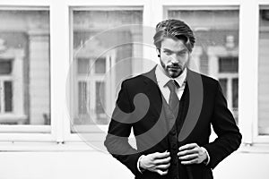 Man or businessman with serious face in black jacket, tie