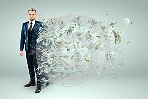 A man a businessman in a suit dissolves, crumbles into dust, money flies out of his body. Concept Bankruptcy, unprofitable