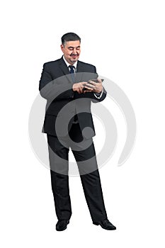 A man businessman in a suit with a smile surfs the news on a tablet