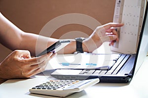 Man busy paying bills online on computer calculating household finances or taxes on machine, female manage home family expenditure