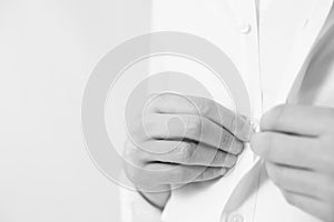 Man buttoning his shirt on