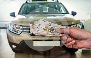 Man buy new car giving euro banknotes