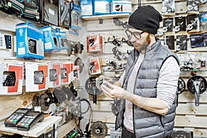 Man buying bicycle parts at the shop