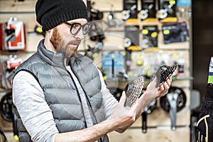 Man buying bicycle parts at the shop