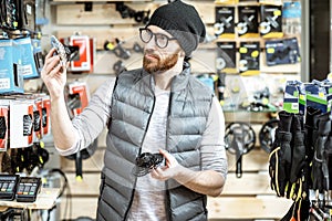 Man buying bicycle parts at the shop