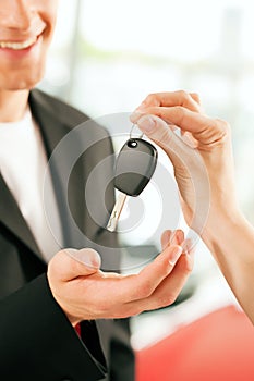 Man buying car - key being given