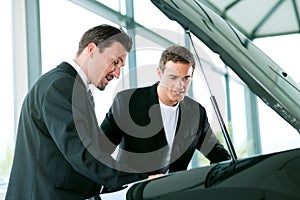 Man buying car from salesperson