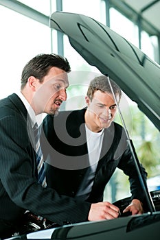 Man buying car from salesperson