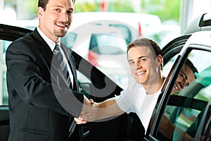 Man buying car from salesperson