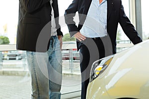 Man buying car from salesperson