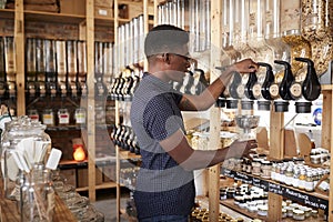 Man Buying Cereals And Grains In Sustainable Plastic Free Grocery Store