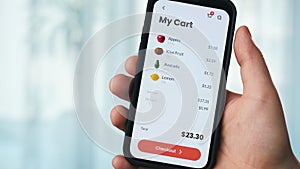 Man buying food online at farmer's market. Grocery store app for mobile phone.