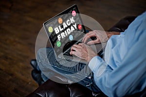 Man buys online on Black Friday. man with a laptop, an adult man`s hands on a keyboard. Sale in Black Friday.