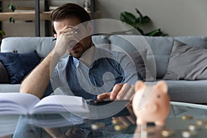 Man calculates expenses feels concerned due money shortage