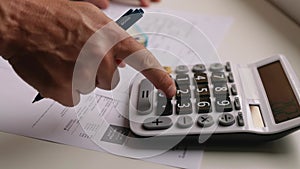Man calculates money on calculator for utilities bills